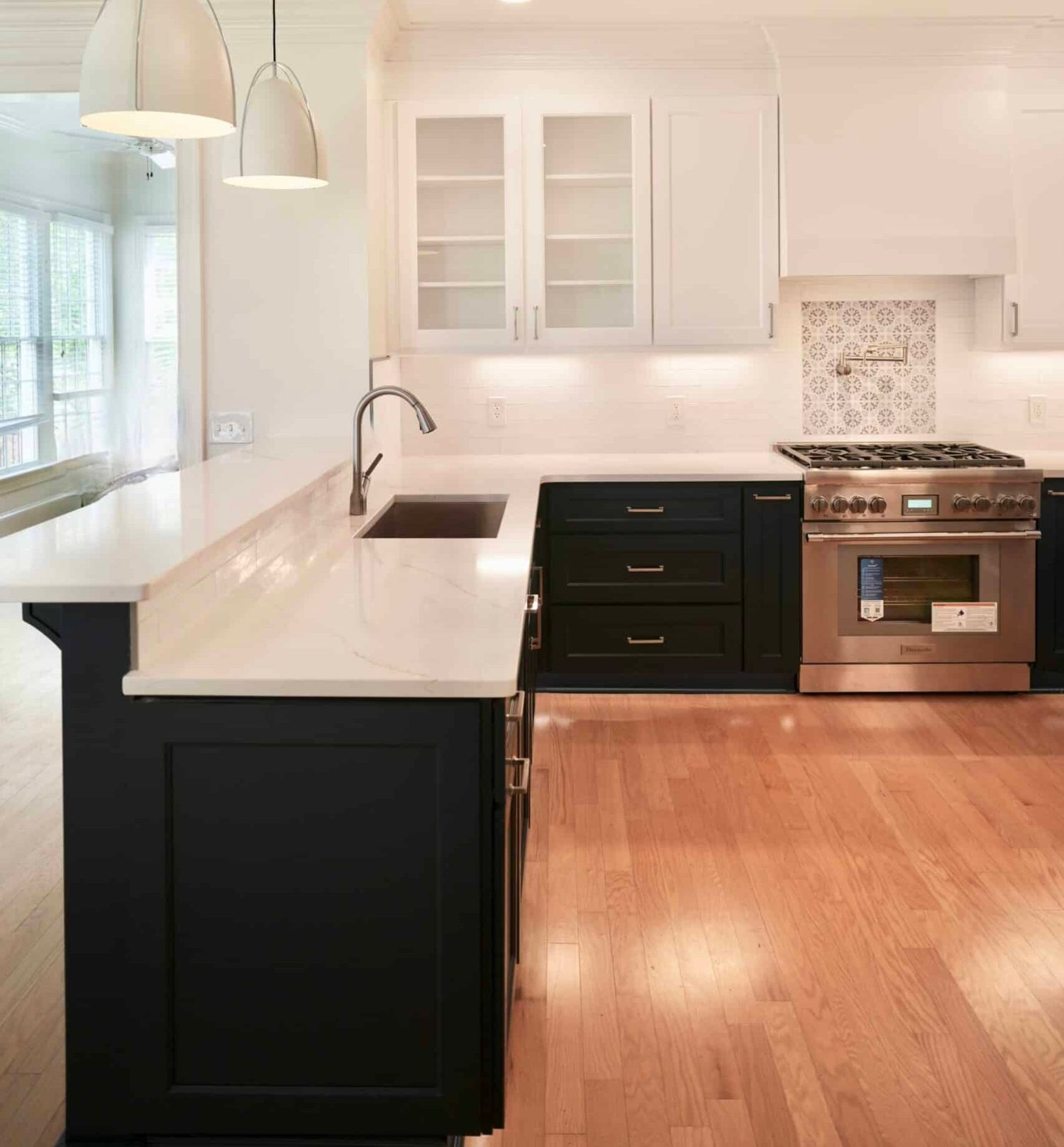 Kitchen remodel in Durham with custom cabinetry and mixed tile and timber floors