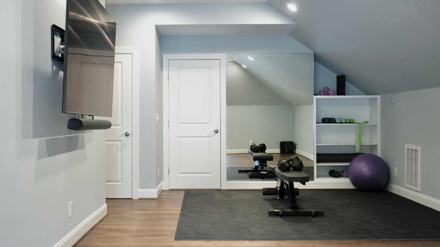 Finished attic living space in Durham with sloped ceilings and a built-in bar