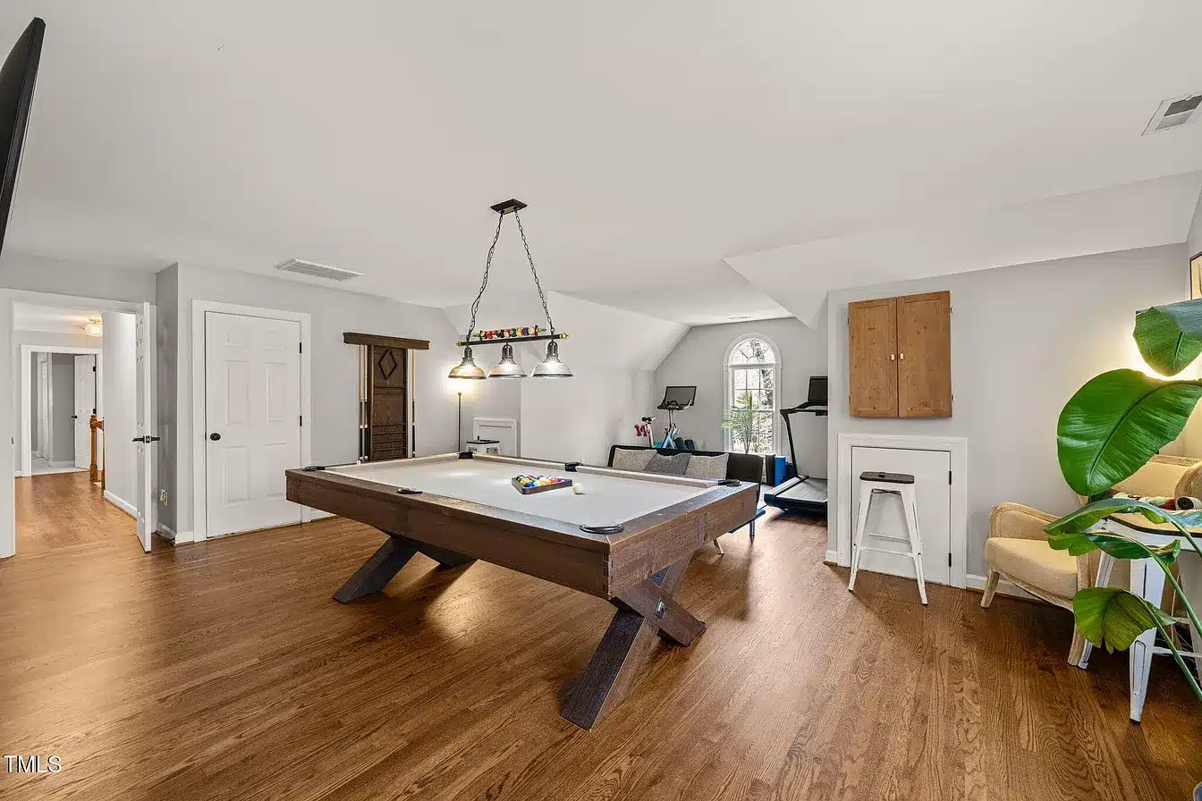 Finished attic bonus room with dormer windows and built-in storage by Green Hill Contracting